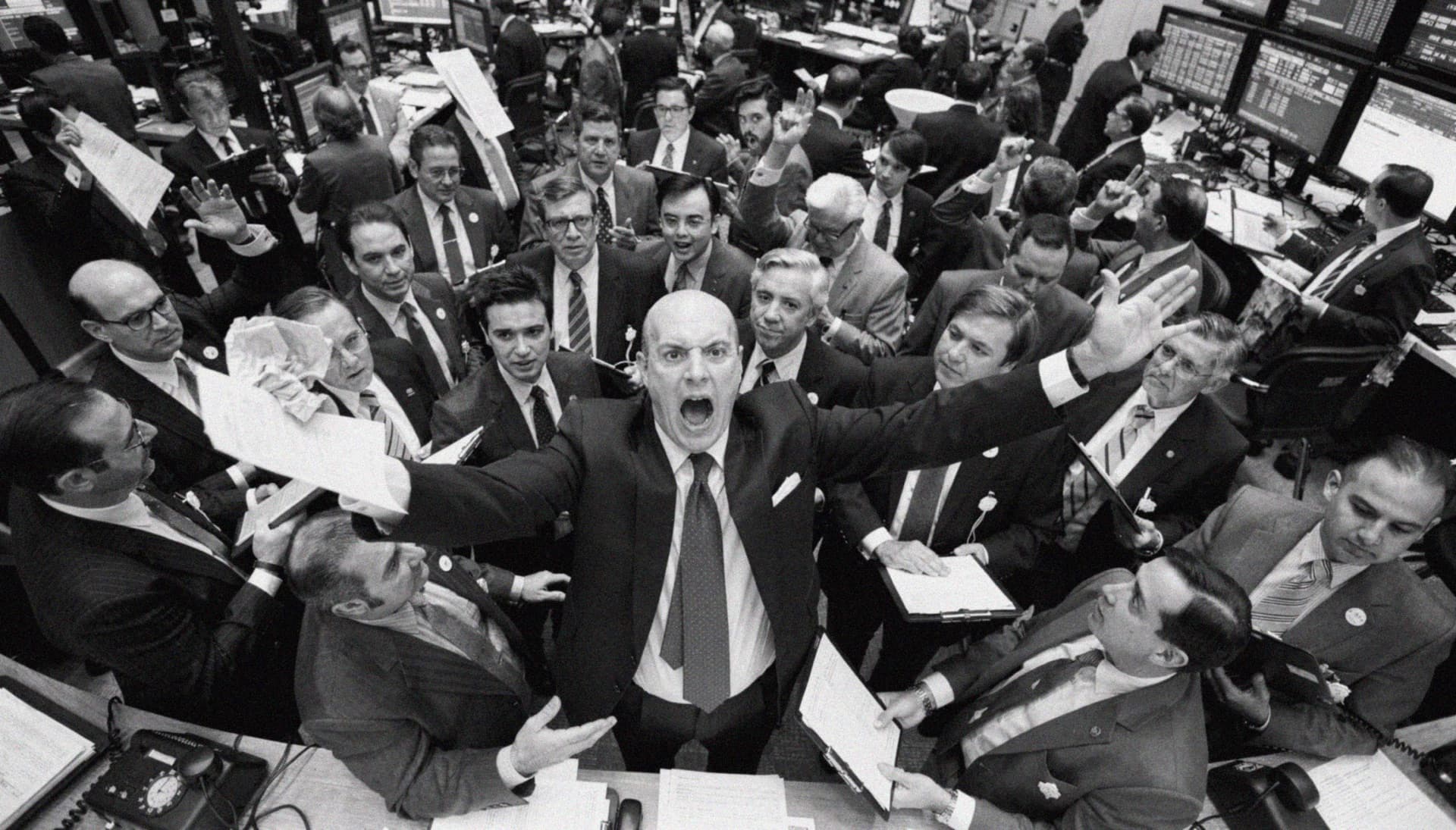 Open-outcry trading floor, arms raised